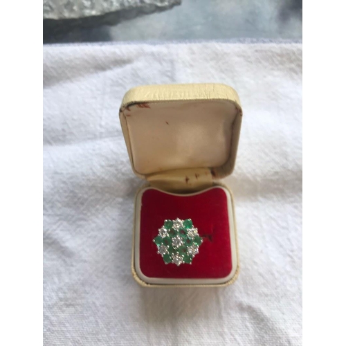 212 - A 9 carat gold emerald and diamond ring. Size Q.