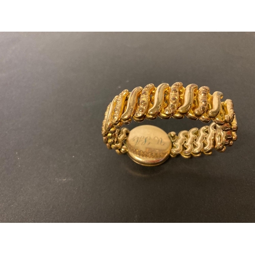 217 - A rolled gold expandable bracelet and locket.