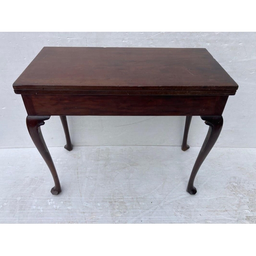 234 - Irish Georgian mahogany fold over tea or side table raised on shaped legs with pad feet.