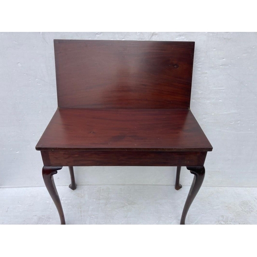 234 - Irish Georgian mahogany fold over tea or side table raised on shaped legs with pad feet.