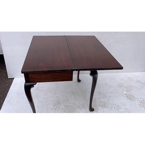 234 - Irish Georgian mahogany fold over tea or side table raised on shaped legs with pad feet.