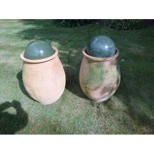 260 - Pair of terracotta pots with balls. Pot height 67cm approx.