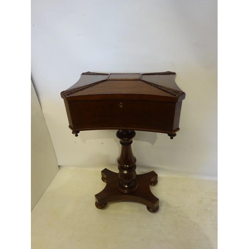 296 - A good 19th century mahogany tea poy, the shaped top with carved decoration opening to reveal a fitt... 