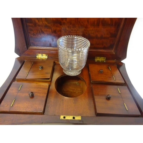 296 - A good 19th century mahogany tea poy, the shaped top with carved decoration opening to reveal a fitt... 