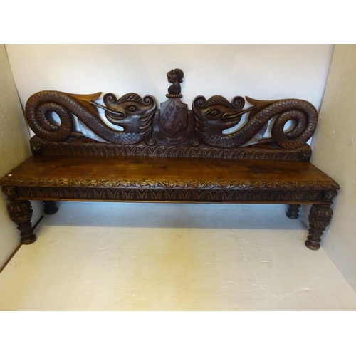 306 - An antique carved walnut hall bench, the back with a central heraldic sheild carved Nun Quam Non Par... 