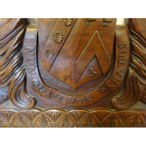 306 - An antique carved walnut hall bench, the back with a central heraldic sheild carved Nun Quam Non Par... 