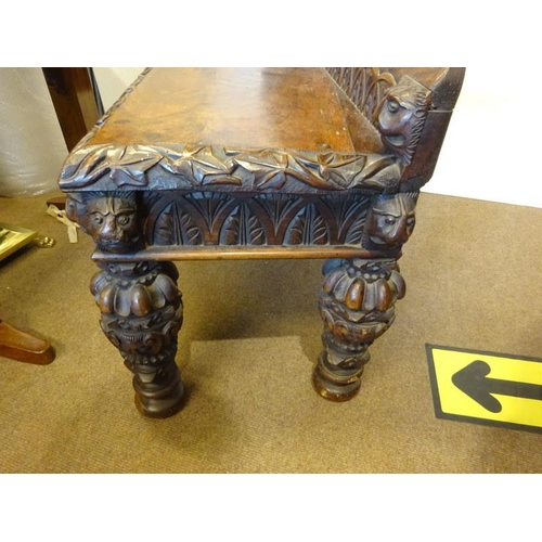 306 - An antique carved walnut hall bench, the back with a central heraldic sheild carved Nun Quam Non Par... 