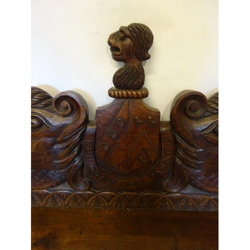 306 - An antique carved walnut hall bench, the back with a central heraldic sheild carved Nun Quam Non Par... 