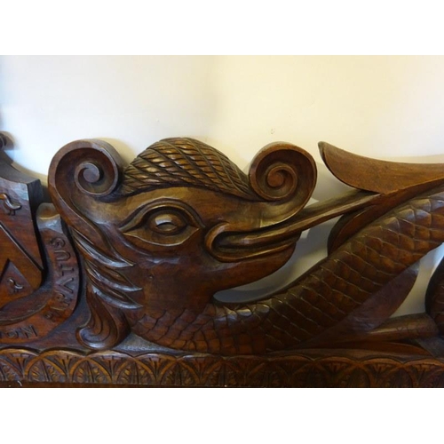 306 - An antique carved walnut hall bench, the back with a central heraldic sheild carved Nun Quam Non Par... 