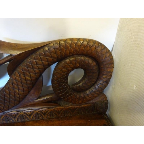 306 - An antique carved walnut hall bench, the back with a central heraldic sheild carved Nun Quam Non Par... 