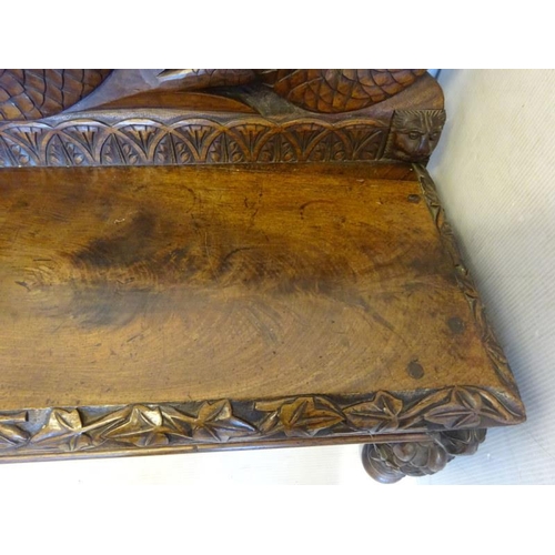 306 - An antique carved walnut hall bench, the back with a central heraldic sheild carved Nun Quam Non Par... 