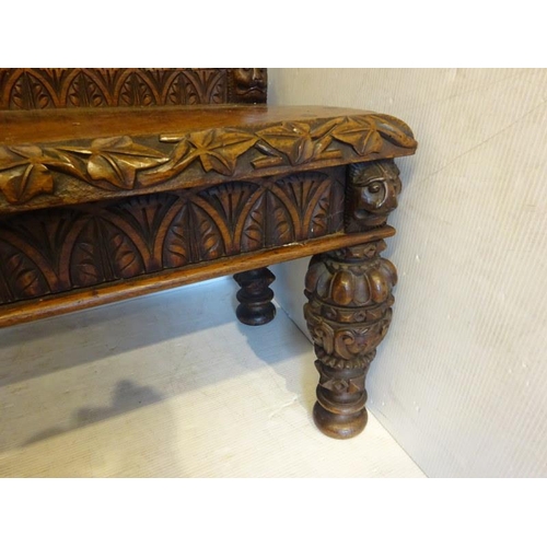 306 - An antique carved walnut hall bench, the back with a central heraldic sheild carved Nun Quam Non Par... 