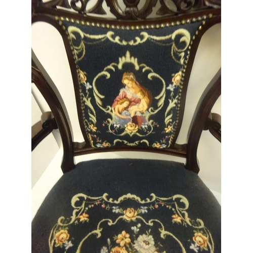 308 - A pair of late 19th century carved mahogany open arm drawing room chairs with needlework upholstery.