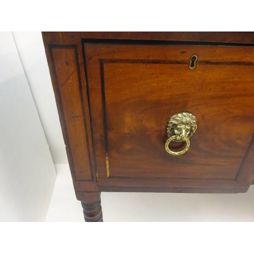 317 - Regency mahogany sideboard, the reeded top over cupboards and drawer with lion mask handles and rais... 