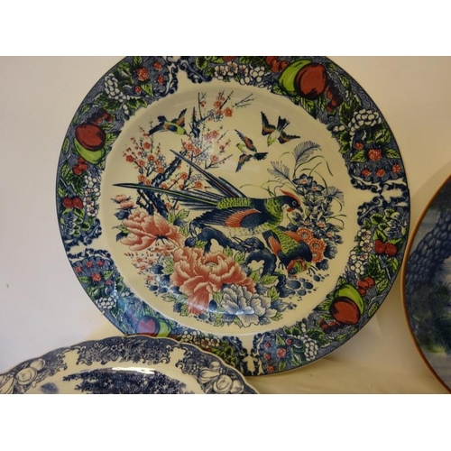 320 - A collection of five circular china wall plaques, Imari, etc.