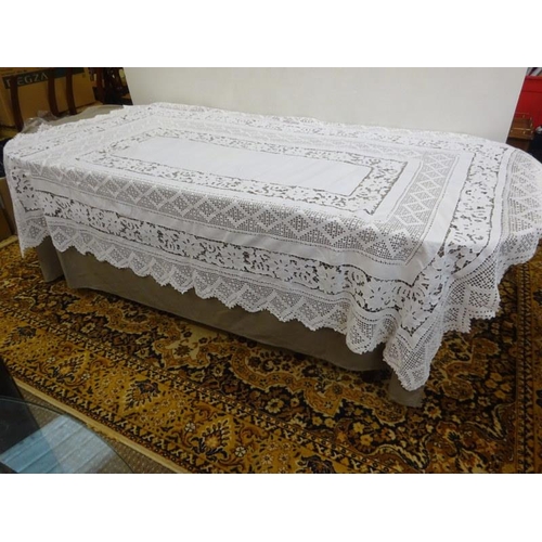 5 - A box of assorted linen to include a large crochet table cloth.  250cm x 165cm approx.