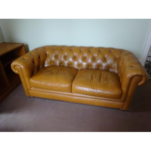 63 - A leather upholstered Chesterfield. W. 180cm, D. 90cm, H. 87cm approx.