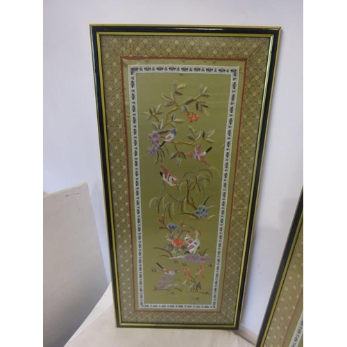 66 - A pair of attractive framed embroidered pictures. Overall size 64cm x 30cm.