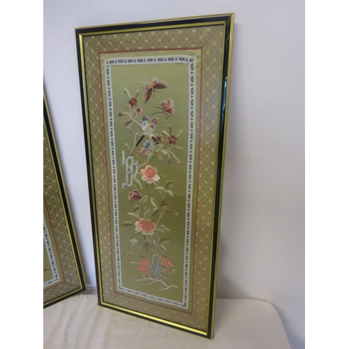 66 - A pair of attractive framed embroidered pictures. Overall size 64cm x 30cm.