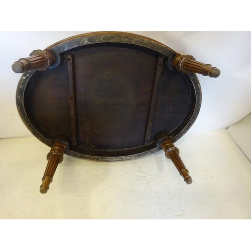 67 - A Victorian walnut coffee table, the oval shaped top raised on fluted tapering legs. L. 120cm, W. 86... 