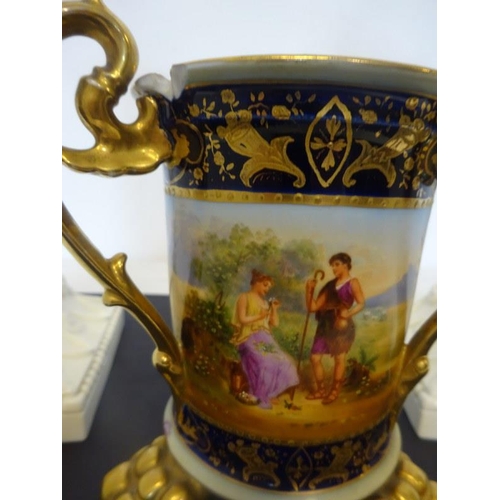 71 - A pair of Royal Worcester corinthian column candlesticks together with a Viennese cup with hand pain... 