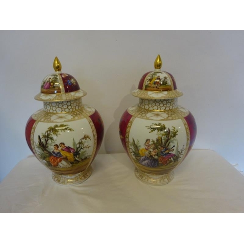 73 - A pair of decorative continental porcelain urns with lids. H. 40cm approx.