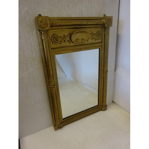 79 - A 19th century gilt framed pier mirror with shell decoration. H. 110cm, W. 70cm approx.