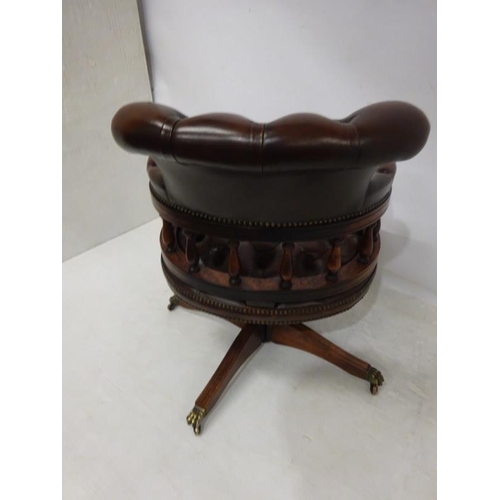 88 - A good leather upholstered and mahogany captains or office swivel chair.