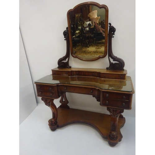 95 - A good Victorian mahogany dressing table, the shaped top fitted with eight drawers, raised on carved... 