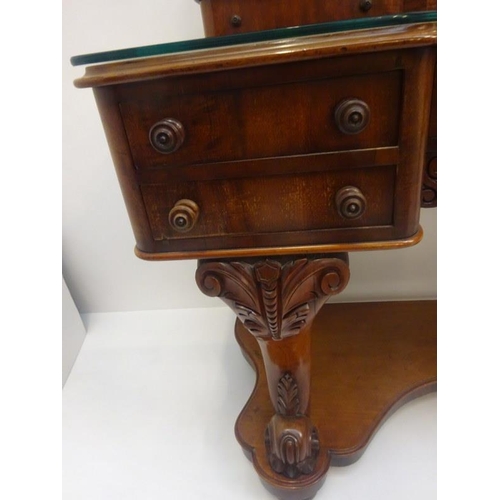 95 - A good Victorian mahogany dressing table, the shaped top fitted with eight drawers, raised on carved... 