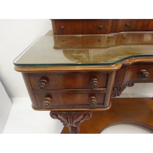 95 - A good Victorian mahogany dressing table, the shaped top fitted with eight drawers, raised on carved... 