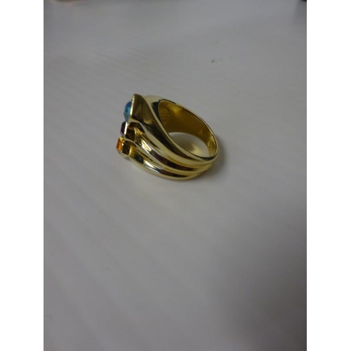 287 - 18 carat gold dress ring with coloured stones. Size R.