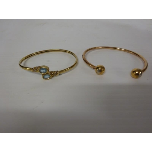 288 - A 9 carat gold bangle with aquamarine stones together with another bangle. 33.13 grams (2)