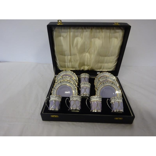 319 - A cased Aynsley China and silver mounted coffee set. Sheffield 1930.