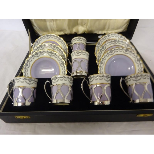 319 - A cased Aynsley China and silver mounted coffee set. Sheffield 1930.