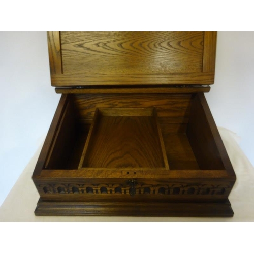 323 - Slope front oak stationery box with leather inset.