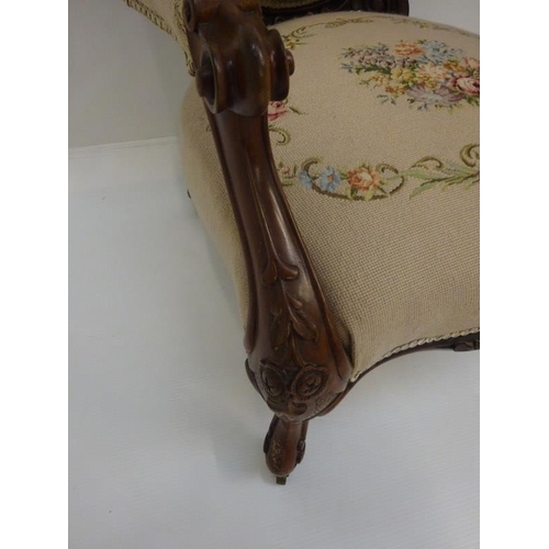 338 - A Victorian open arm drawing room chair with needlework upholstery.