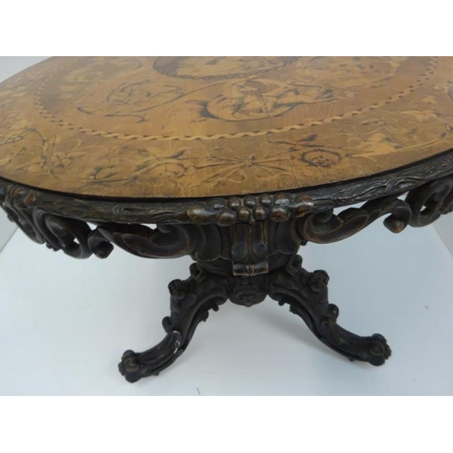 340 - A good 19th century Irish circular table, the walnut top extensively inlaid having carved freize and... 