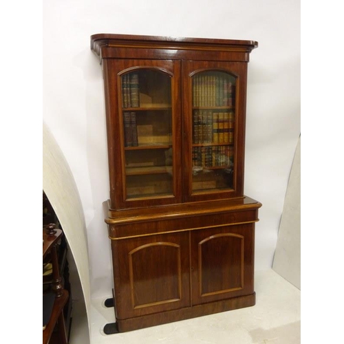 351 - Victorian mahogany two door bookcase, the upper section with glazed doors, the base fitted with a lo... 