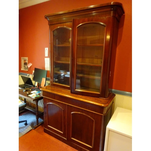 351 - Victorian mahogany two door bookcase, the upper section with glazed doors, the base fitted with a lo... 