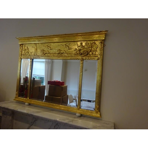 353 - Antique gilt framed over mantle mirror with chariot decoration. 124cm x 90cm.