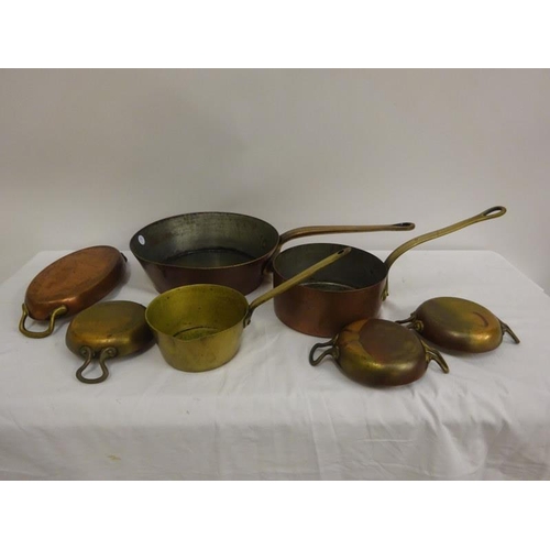 358 - A quantity of old copper saucepans and dishes.