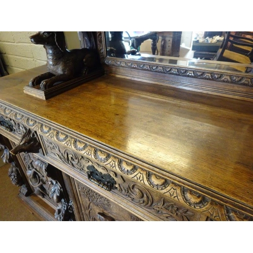 105 - A good large 19th century black forest sideboard, the upper section having carved eagle flanked by f... 