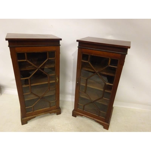 120 - A pair of antique Irish design mahogany side cabinets each having a section glass door, shelved inte... 