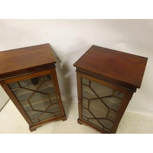 120 - A pair of antique Irish design mahogany side cabinets each having a section glass door, shelved inte... 