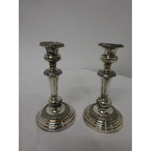 150 - A good pair of antique Sheffield plated candle sticks on circular bases.