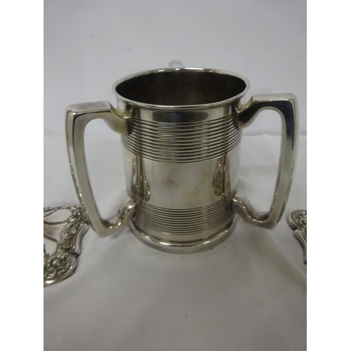 158 - A pair of Sheffield plated candlesticks and a three handled tankard.