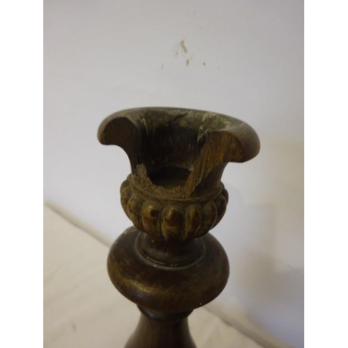 16 - Two old carved wood candle holders, (some damage).