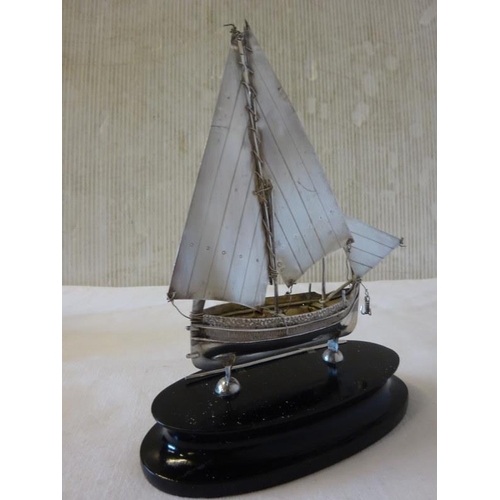 177 - Maltese silver sailing boat and oar mounted on timber plaque.