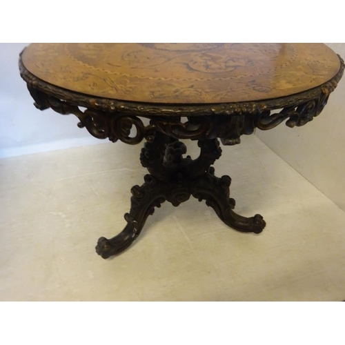 190 - A good 19th century Irish circular table, the walnut top extensively inlaid having carved freize and... 